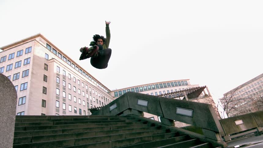 A rollerblader jumping down city steps