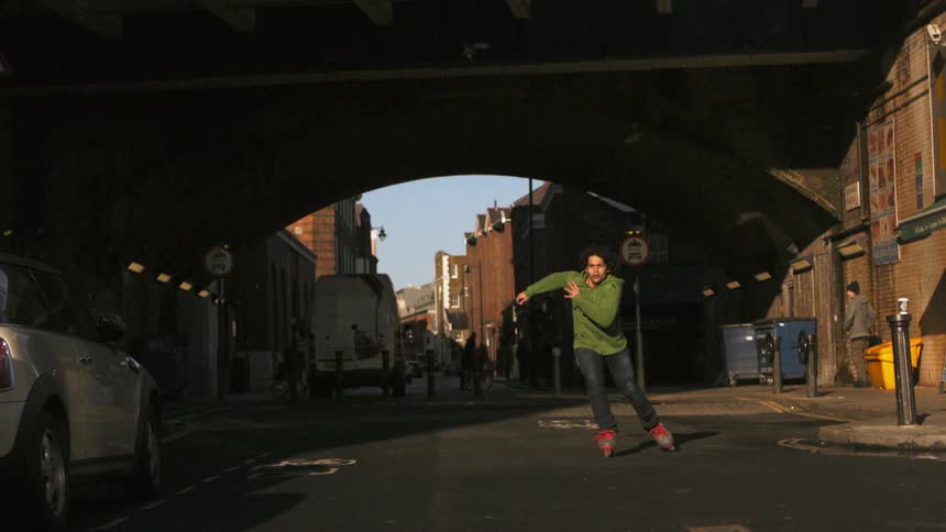 Man rollerblading on the street on a sunny day