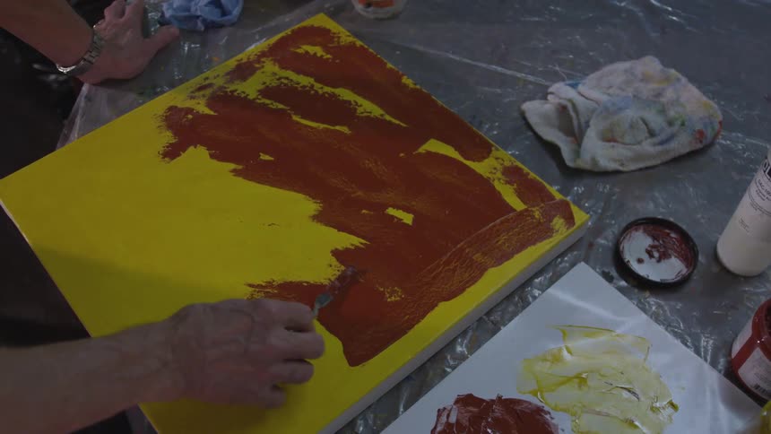 Older Man Painting In Studio