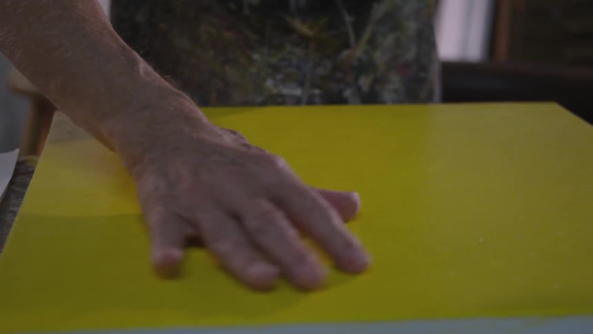 Older Man Painting In Studio