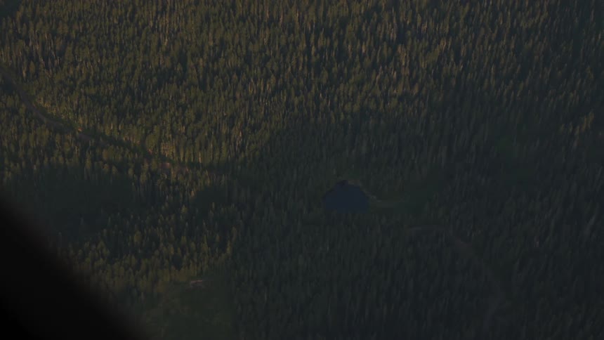 Pilot Flying Plane Through Snowy Mountains