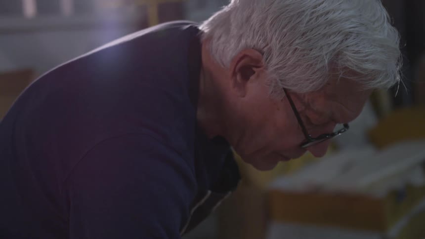 Older Man Painting In Studio