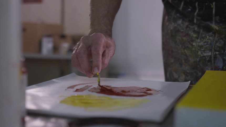 Older Man Painting In Studio