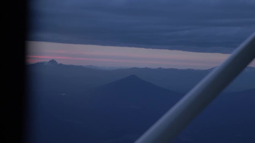 Pilot Flying Plane Through Snowy Mountains