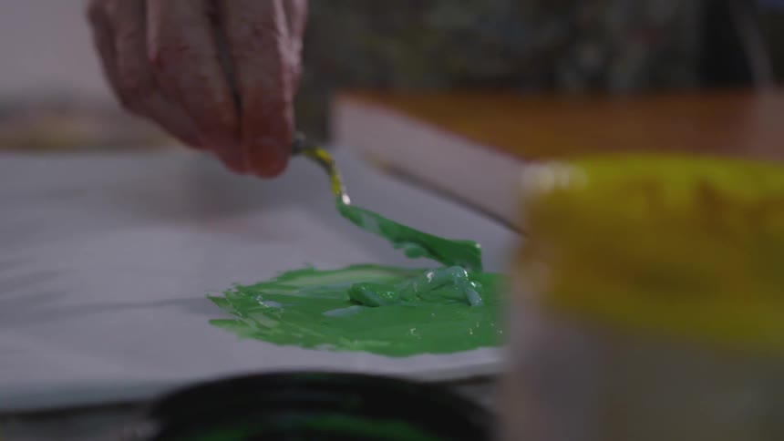 Older Man Painting In Studio