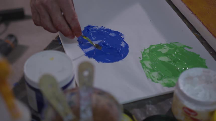 Older Man Painting In Studio
