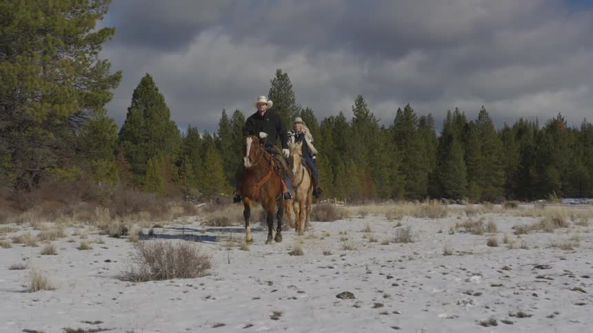 People Riding Horses In Snow