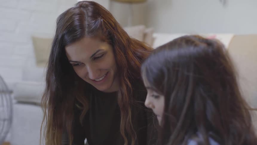 Mother Helping Daughter With Homework