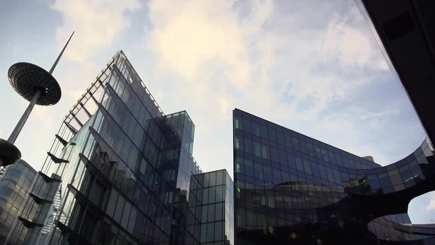 Clouds floating over city buildings