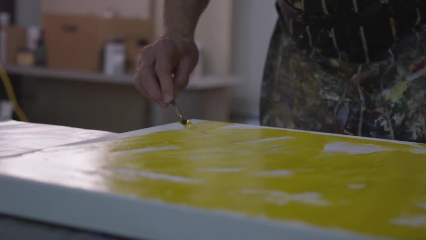 Older Man Painting In Studio