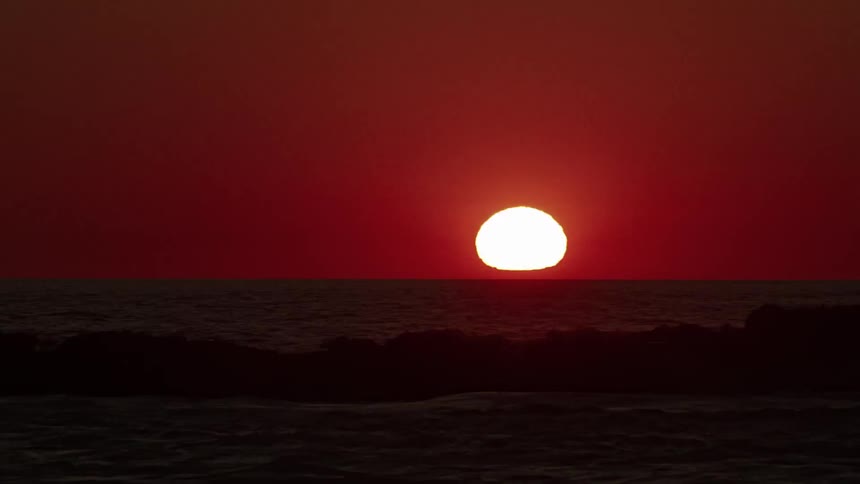 Time lapse of a sun setting over an ocean