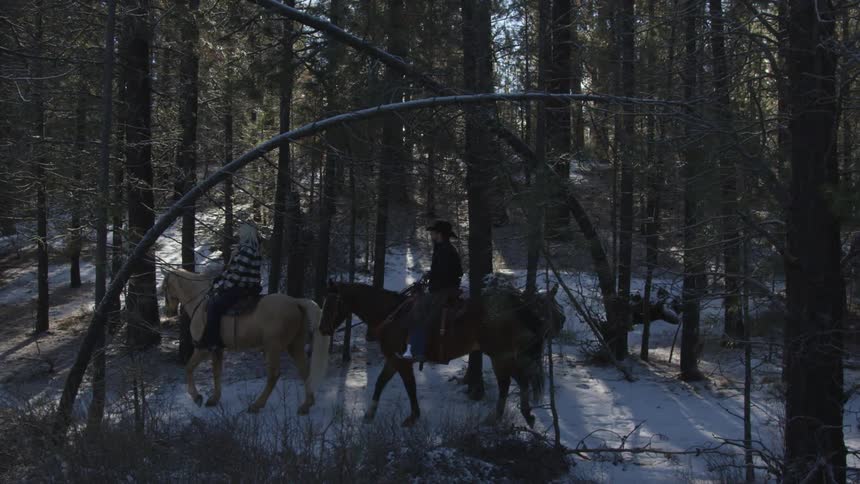 People Riding Horses In Snow
