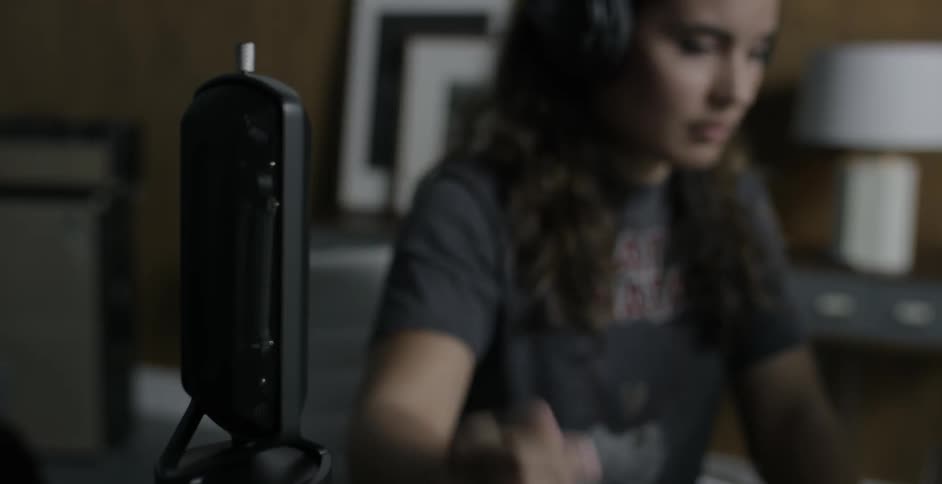 A woman snapping her fingers into a microphone