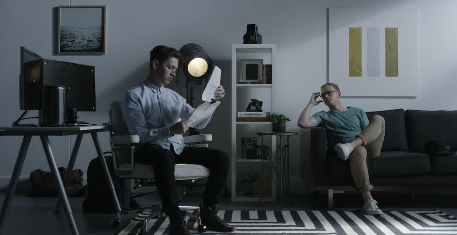 Two young men work together on a screenplay or manuscript