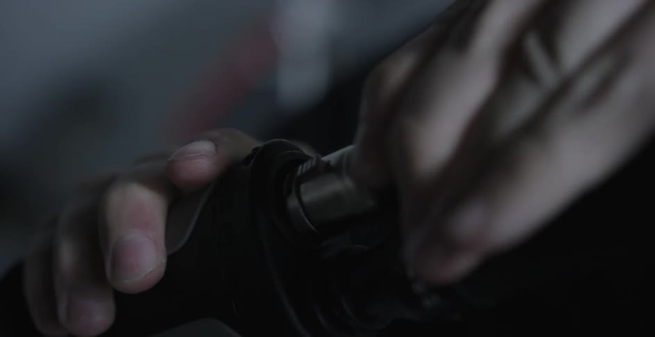 A person plugging a wire into a small outlet