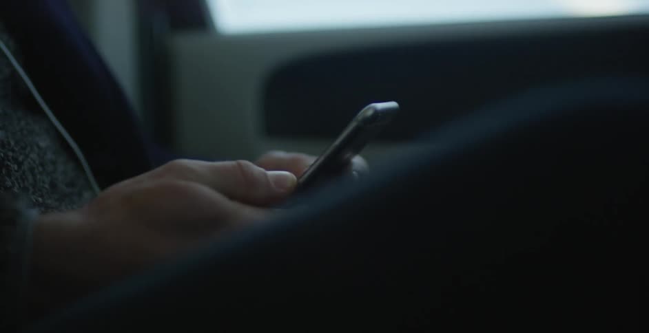 Person sitting in a vehicle using a cell phone