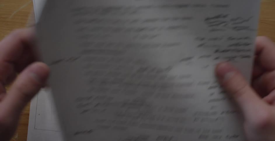 Someone looks through a script with illustrations and revisions