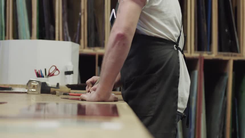 Man wearing black apron working in studio