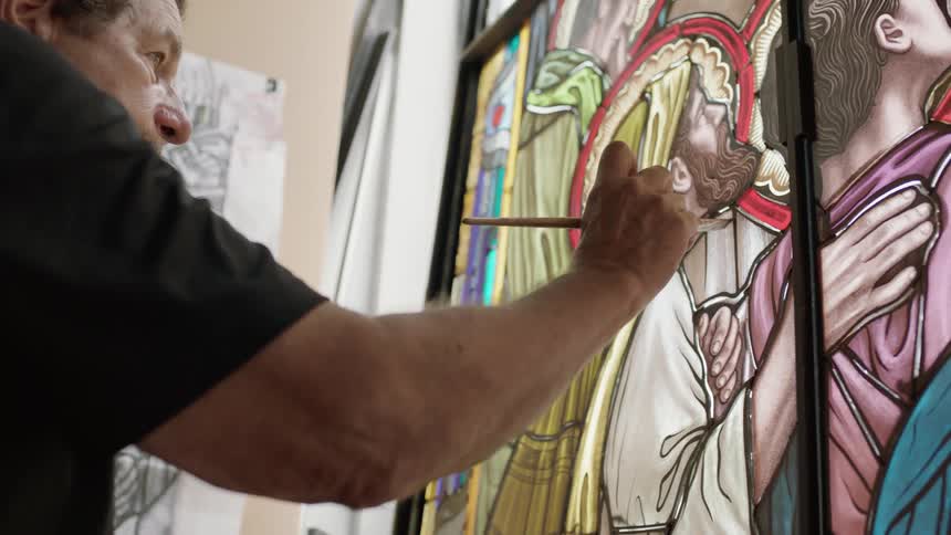 Older man painting stain glass image