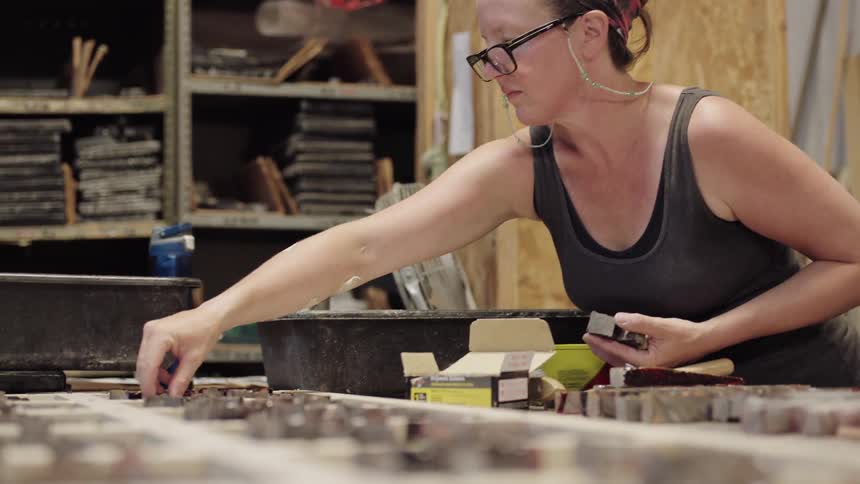 Woman creating art on table