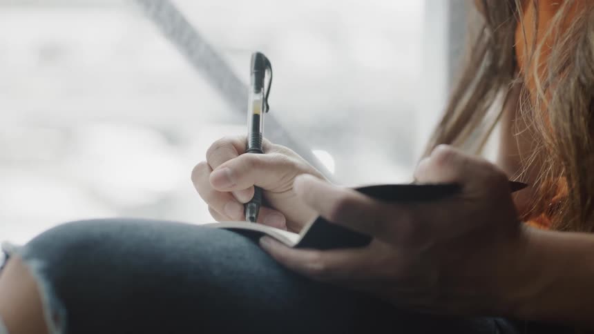 Woman writing in journal