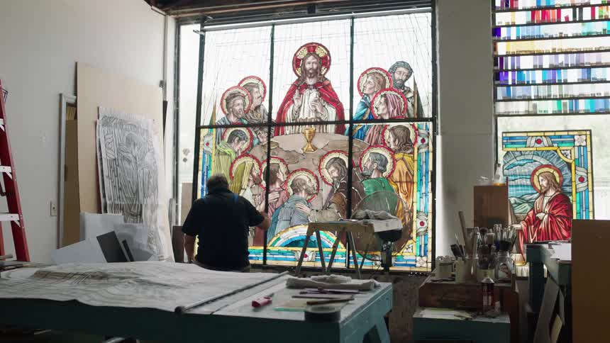 Large stain glass window with painter working