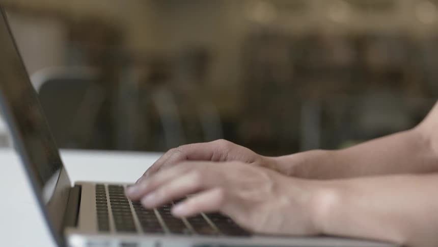 Hands working on a computer