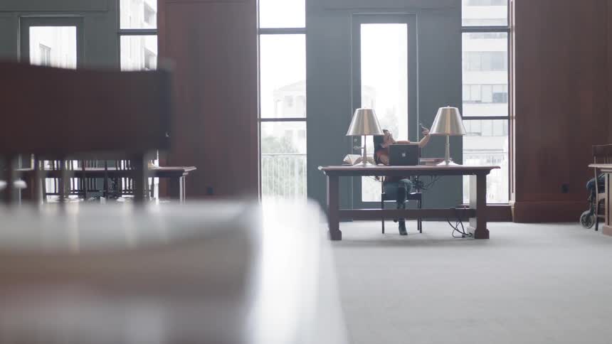 Student working at table in large room