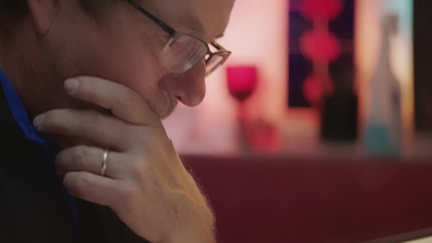 Designer with hand on face working on project