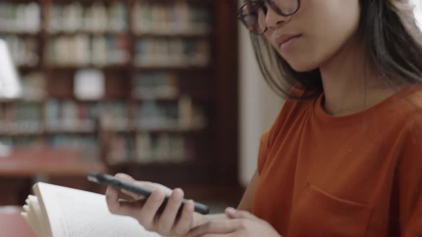 Student using cellphone while studying