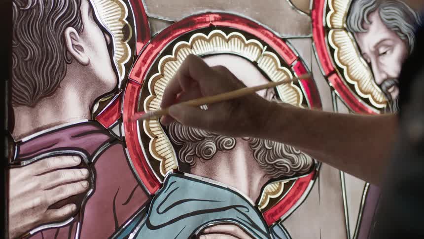 Person in black shirt holding brush painting