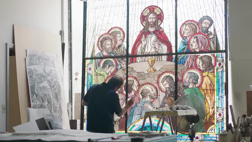 Artist works on large stain glass image of last supper