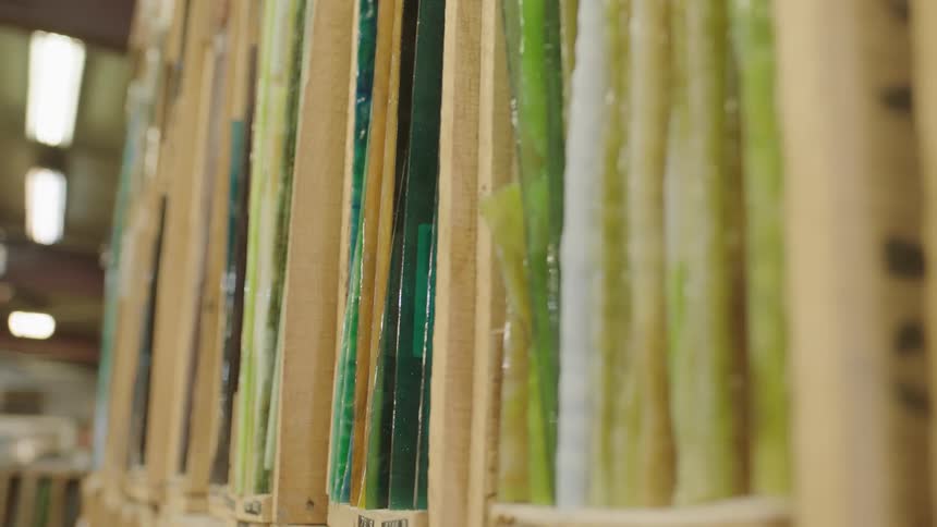 Colored glass organized on shelf