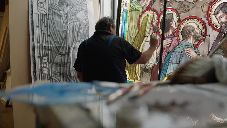 Art supplies surrounding a painter working