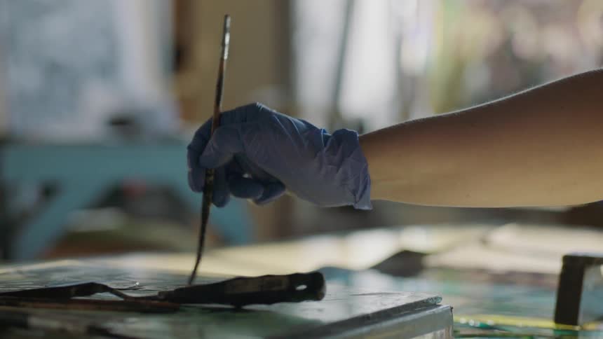 Hand moving backward and forward with paint brush