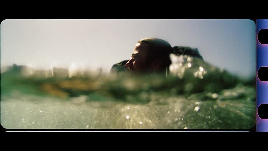 Man swimming in the ocean breathing above the water