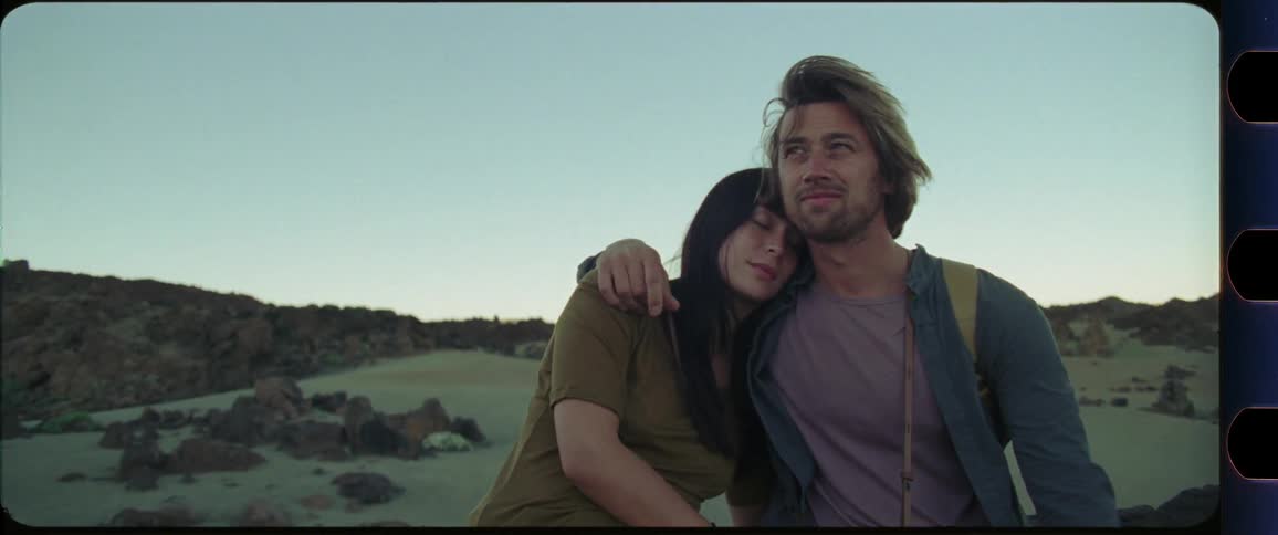 Couple hugging in front of desert scenery