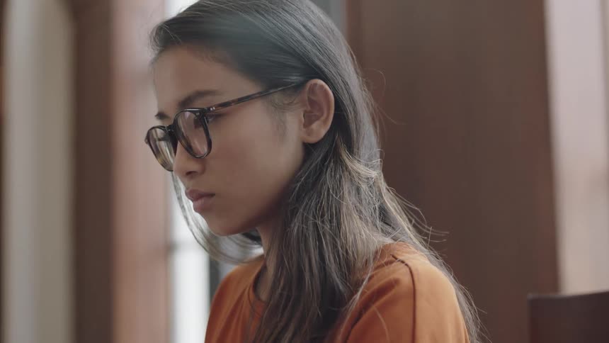 Asian woman moving hair behind eye