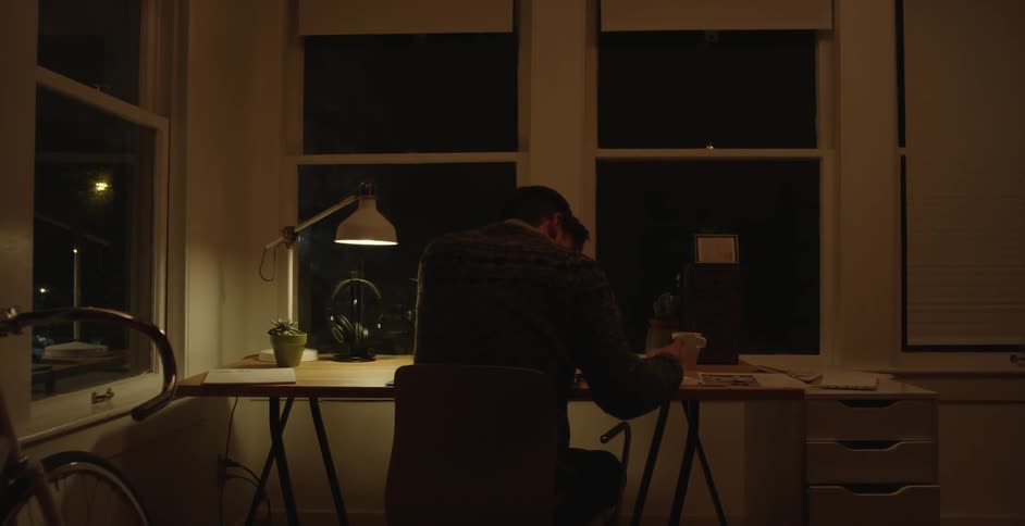 A man sitting down at a table examining papers
