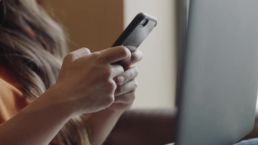 Young woman texting on phone