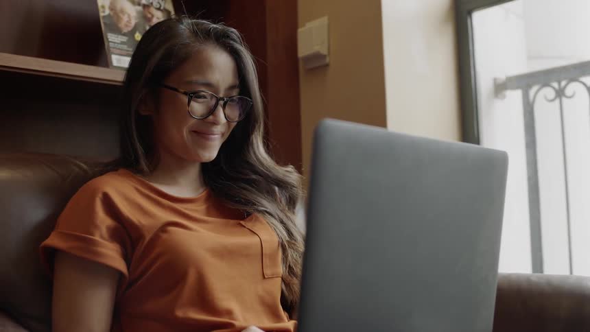 Young adult pucker lips looking at laptop screen