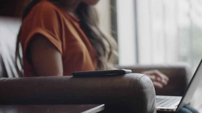 Woman witting in armchair with computer