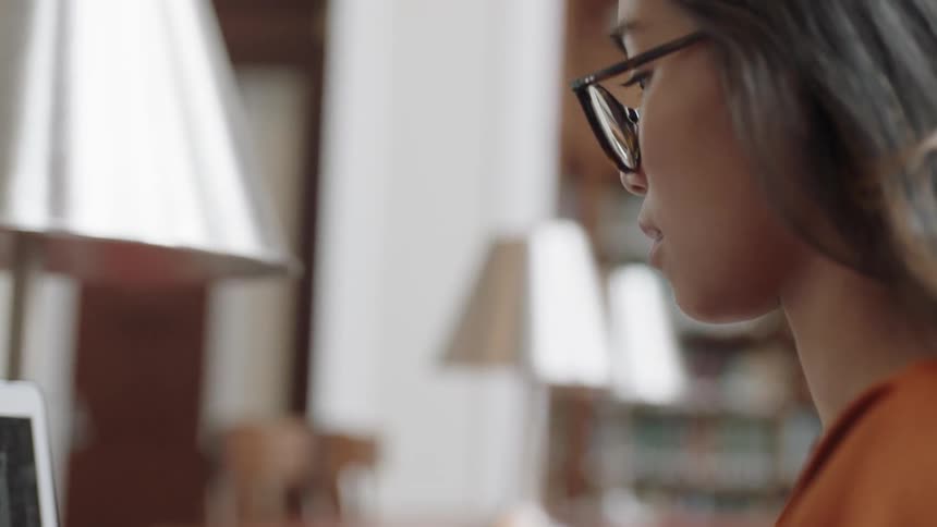 Student looking down to screen on laptop