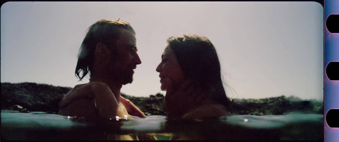 Couple laughing and kissing in the water
