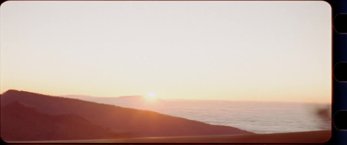 Coastline at sunset from a driving car perspective