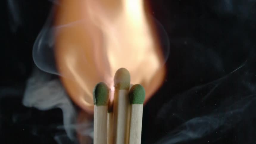 A bunch of matches lighting up into a flame in slow motion