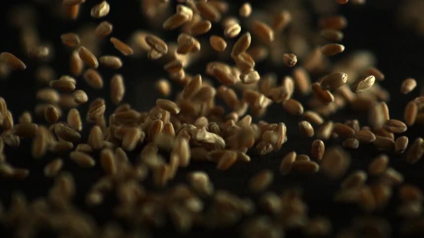 Peanuts falling onto a black surface