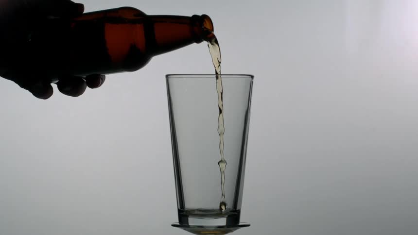 A beer poured into a glass in slow motion