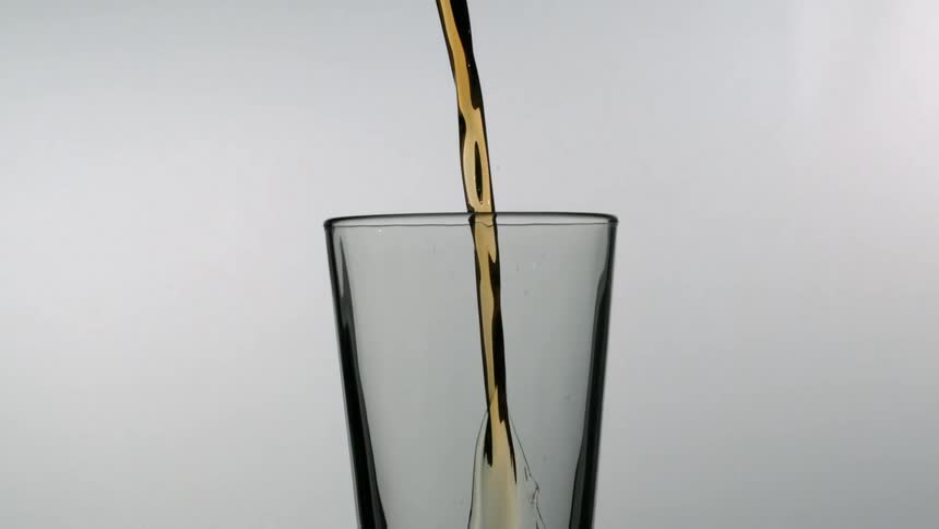 Bottled beer being poured into a glass