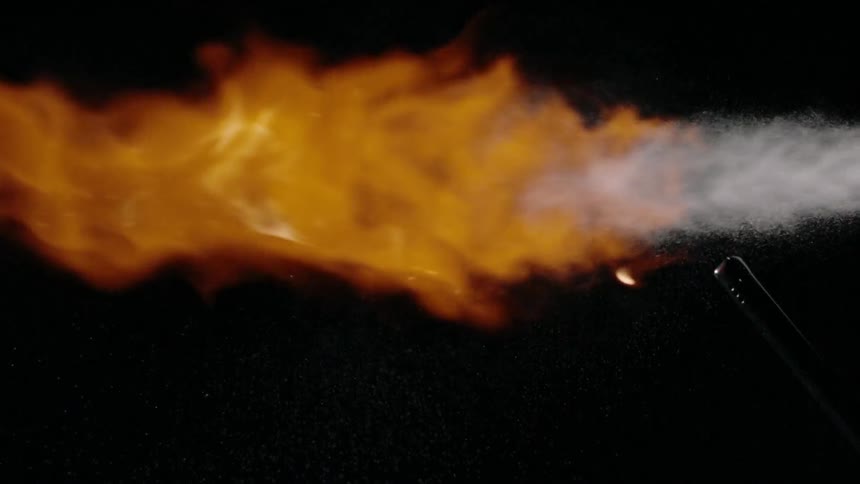 A white substance is set on fire with a long lighter